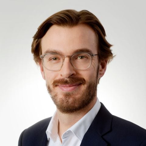 Headshot of Luke Sandford, smiling to camera