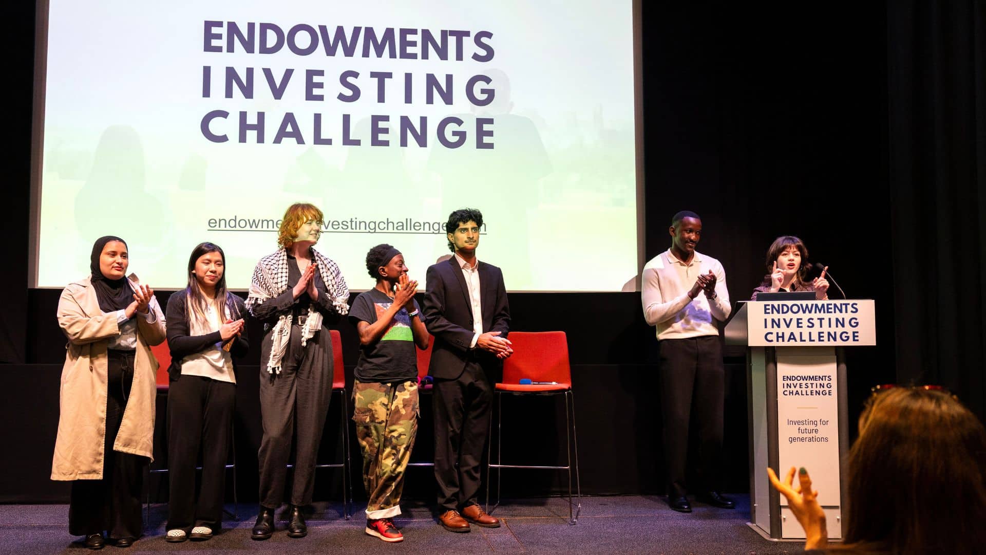 The Future Generations Panel (a diverse group of seven young people) on stage at the Endowments Investing Challenge event.