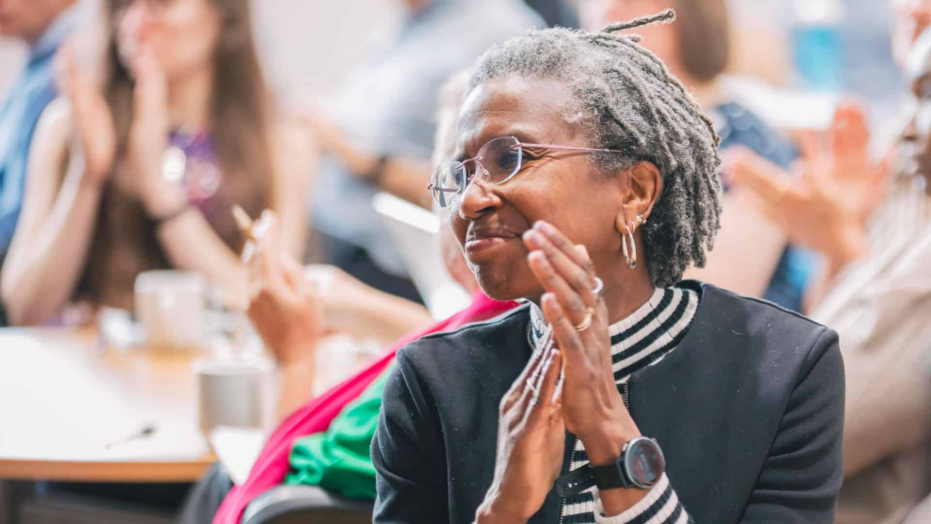 Conference photo with Danielle Walker Palmour in focus at the front of the image